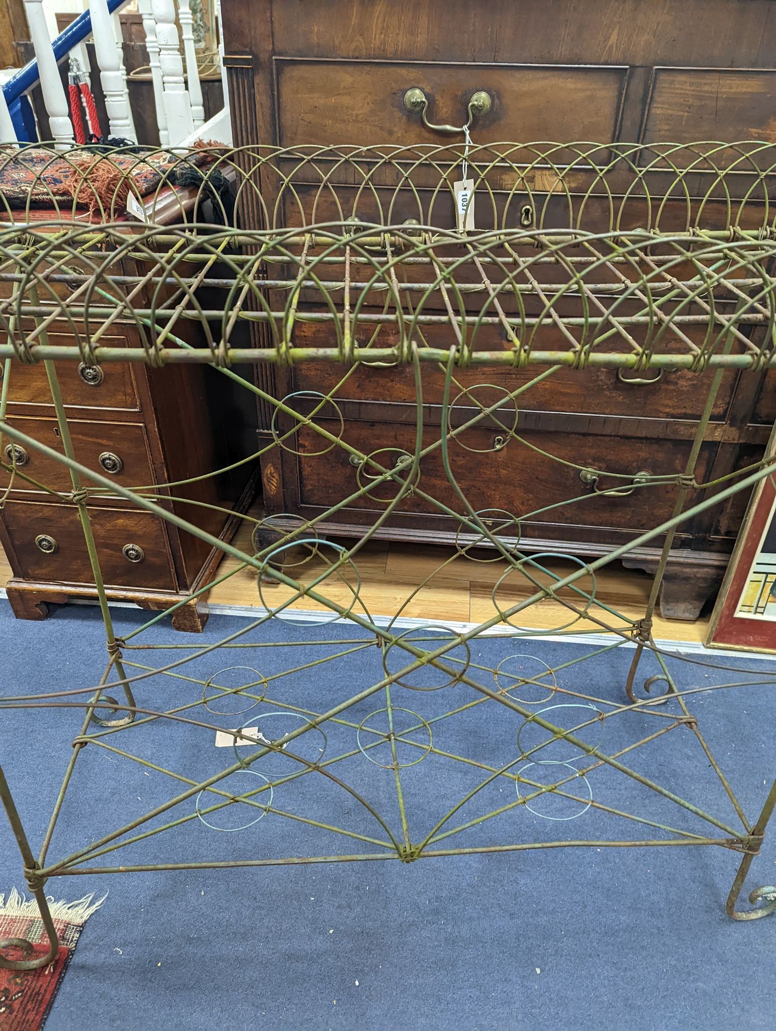 A wirework pot stand, width 122cm, depth 43cm, height 90cm